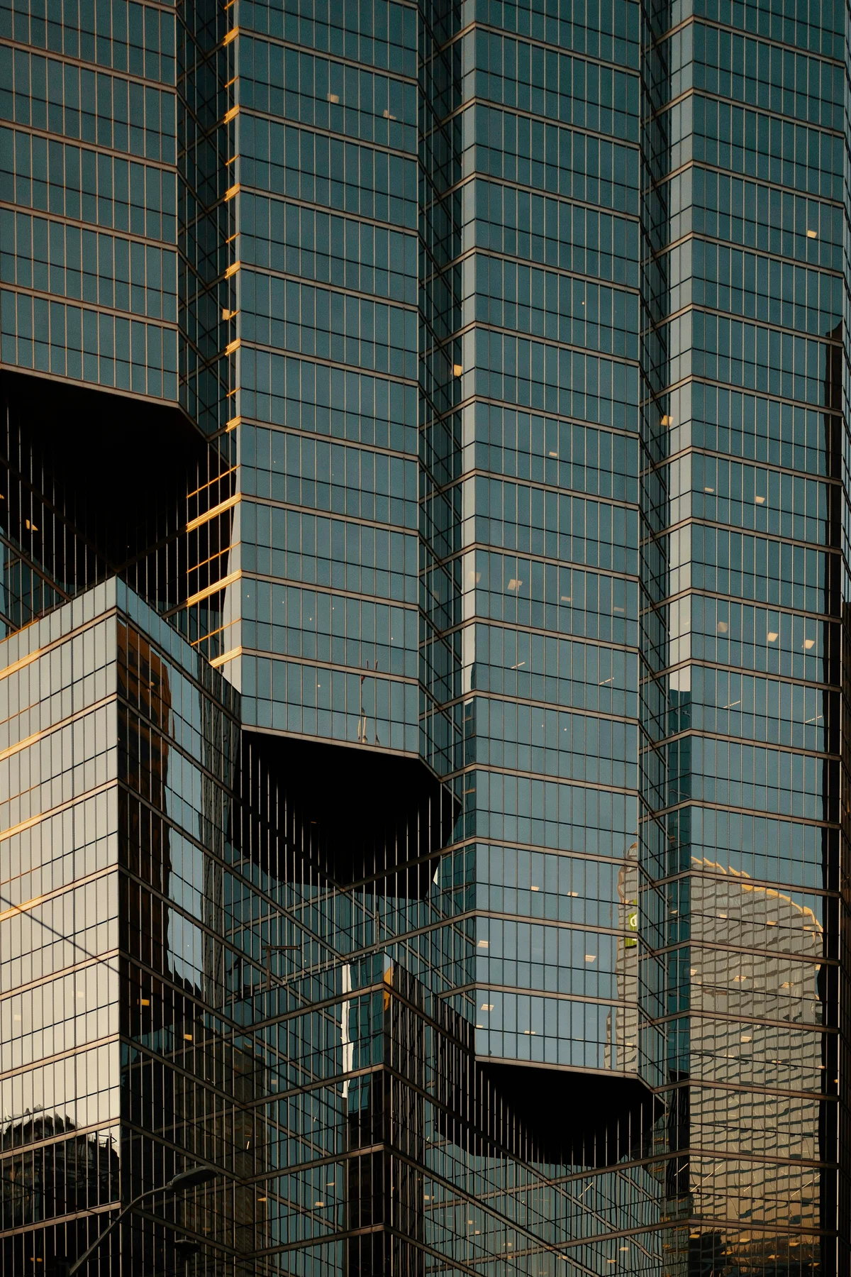 Intersecting glass facades, structural lines and reflected evening light